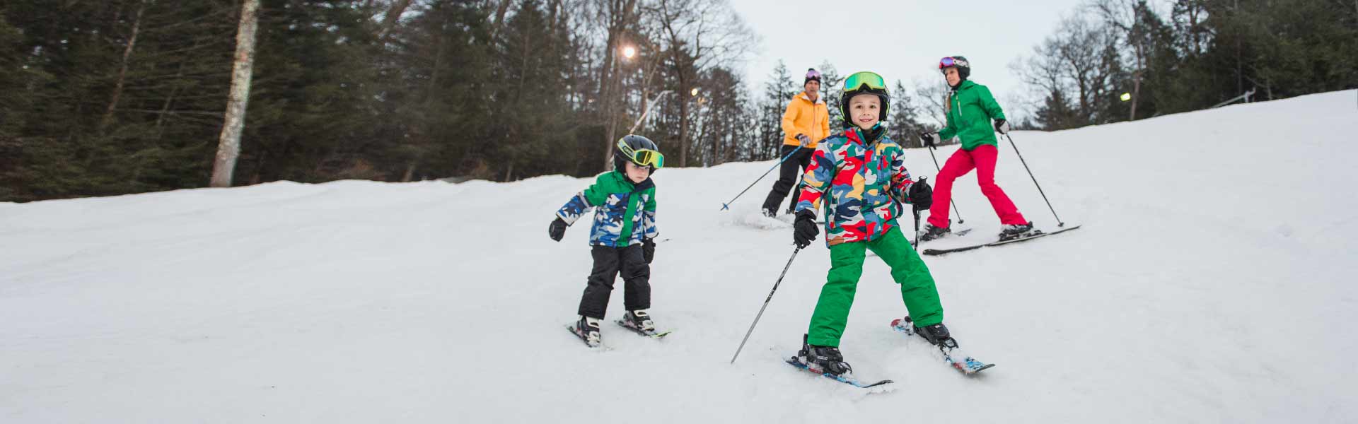 Young family of skiers enjoying the slopes.