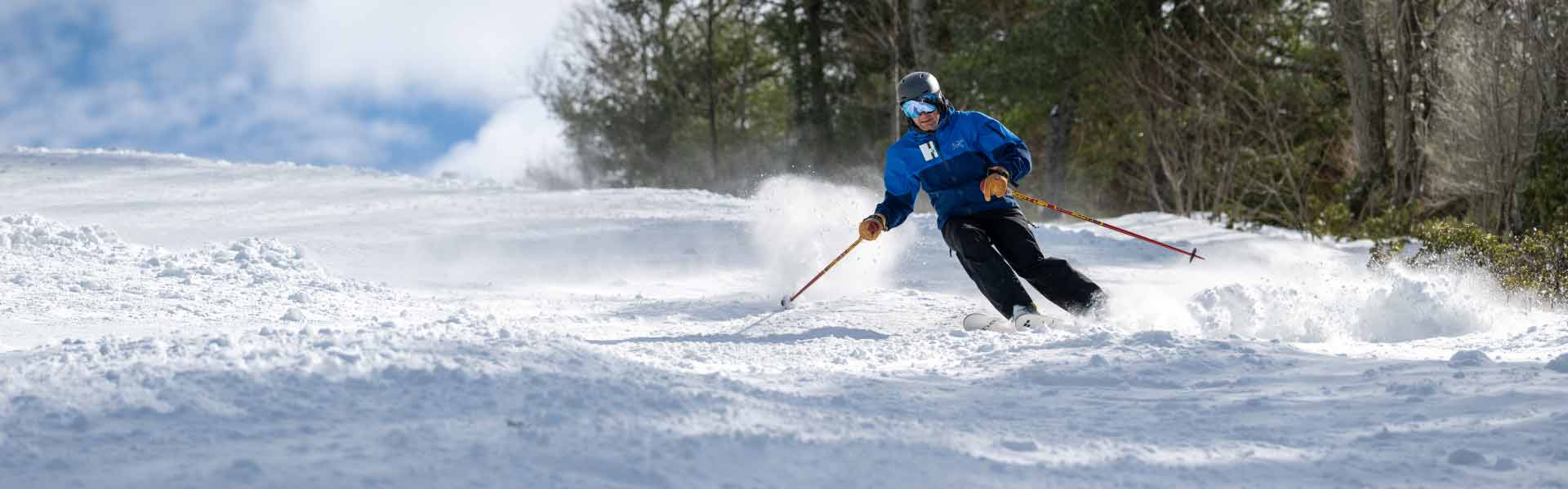 Skier parallel skiing down slope at Ski Sundown.